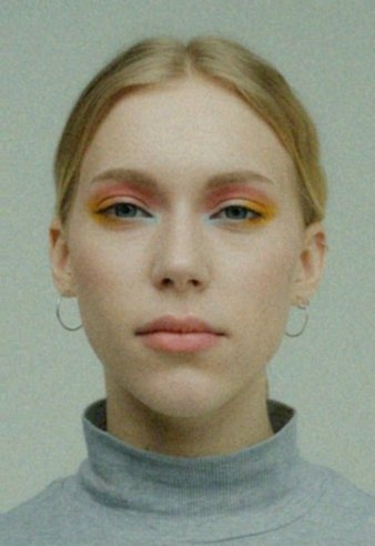 A synthetic attack face after a phone-capture submission path, light female cell
